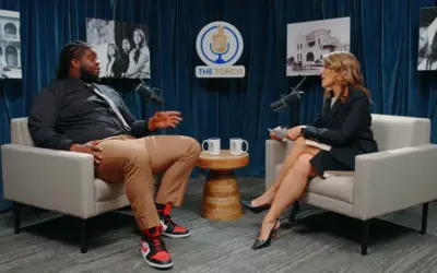 Host and guest sitting in The Torch interview studio