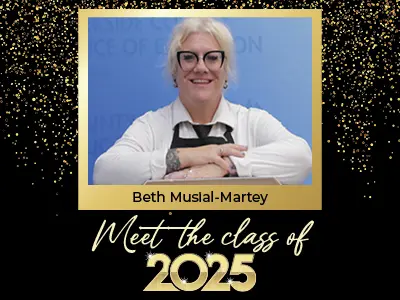 Meet the Class of 2025: Beth Musial Marley. Sstudent smiling wearing apron